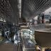 Inn Kawashima Kyoto atrium with glass roof, metal lattice ceiling, and elevated walkway