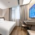 Hanting Hotel Guangzhou Zhongshanba Metro Station guest room with double bed and desk in Guangzhou