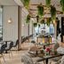 Capri by Fraser, Bukit Bintang in Kuala Lumpur dining area with hanging greenery and modern tables