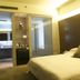 Zhuhai Zobon Art Hotel in Zhuhai: modern guest room with king bed and adjoining bathroom vanity
