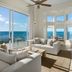 Ambergris Cay Private Island living room with floor-to-ceiling ocean views in Big Ambergris Cay