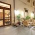 Grande Albergo Alfeo in Siracusa courtyard seating area with potted plants and warm exterior lighting