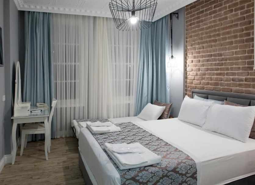 Luna Boutique Hotel Antalya guest room with king bed, desk, and sheer curtains