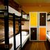 Urban Hostel Bangkok dorm room with black bunk beds, white linens, and colorful locker doors
