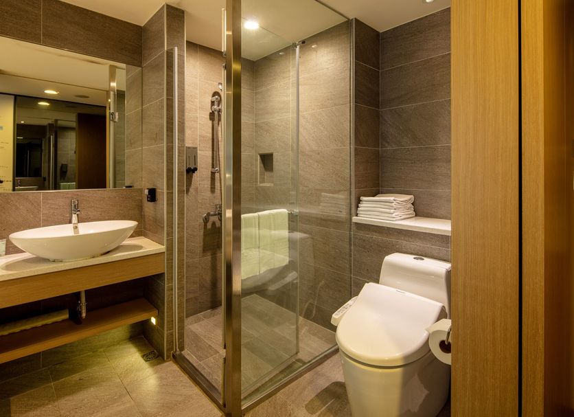 Chaiin Hotel - Dongmen bathroom with glass shower, vessel sink and toilet in Taipei City