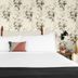 Arrive Memphis guest room with king bed, floral wallpaper, bedside lamps and a cozy accent pillow.