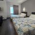 Motel 6-Joliet, Il - Chicago - I-55 room with two beds and wall sconces in Joliet