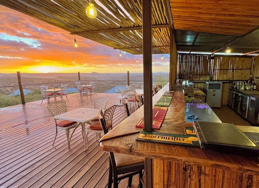 River Crossing Lodge Windhoek rooftop bar with sunset views over the deck and surrounding hills