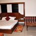 Hotel Mountview International, Katra guest room with bed, striped sofa chairs and wooden coffee table