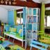 La Villa Des Violettes in Toulouse: colorful lounge with green-and-blue seating and outdoor garden view