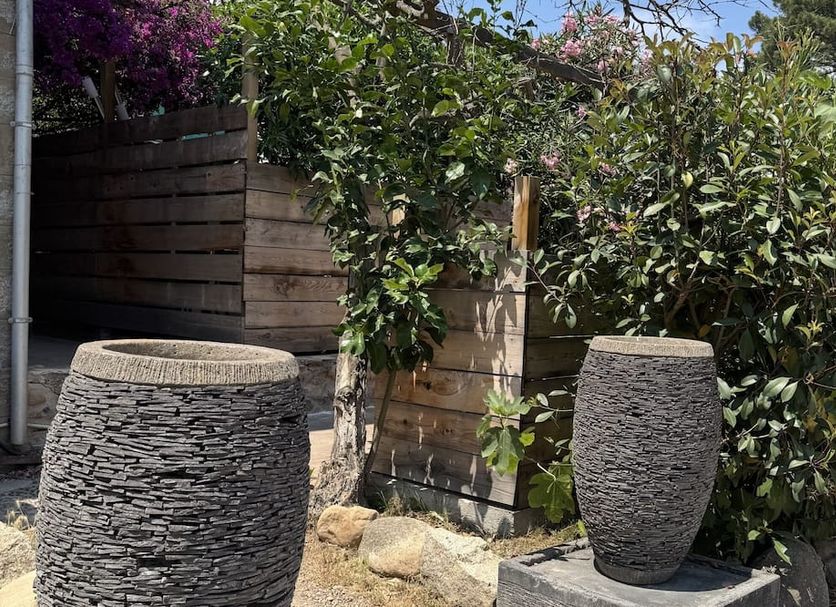 Chambres d'Hôtes Terra Bella in Sainte-Lucie-de-Porto-Vecchio with stone garden planters and greenery