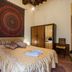 La Gemma Di Elena in Lucca: guest room with double bed, tapestry wall hanging, wardrobe and bedside lamps