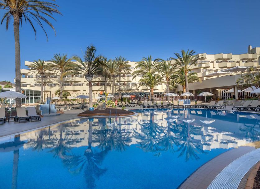 Barceló Corralejo Bay - Adults Only in Corralejo with a palm-lined outdoor pool and sun loungers