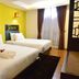 Swiss Hotel Heritage Boutique Melaka guest room with two twin beds and a window with curtains in Malacca