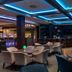 Crowne Plaza Vilnius in Vilnius lounge bar with blue-lit ceiling, tables and upholstered chairs