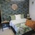 Chambre d'hôtes Au Nid du Thil in Beauvais, bedroom with tropical bedspread and textured walls