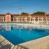 Red Roof Inn Virginia Beach - Norfolk Airport outdoor pool with deck and hotel building in Virginia Beach