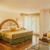 El Rodeo Estancia Boutique Hotel & Steakhouse in San Antonio: room with bed, sofa and floor-to-ceiling windows