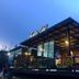 Kondee Cino Cafe and Glamping in Khao Kho, glass-front cafe building with covered terrace at dusk