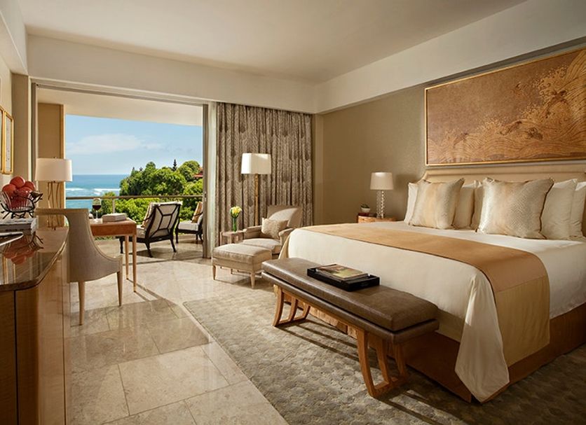 Mulia Resort in South Kuta guest room with king bed, balcony seating, and ocean view