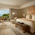 Mulia Resort in South Kuta guest room with king bed, balcony seating, and ocean view