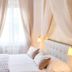 Soggiorno La Coccinella in Florence, a cozy bedroom with canopy drapes and tufted headboard
