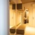 Didimos Town Hotel Reggio Calabria hallway with mirrored wall, bench seating, hooks, and bathroom sink