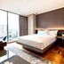 Ramada Encore by Wyndham Makati guest room with king bed and city view through floor-to-ceiling windows