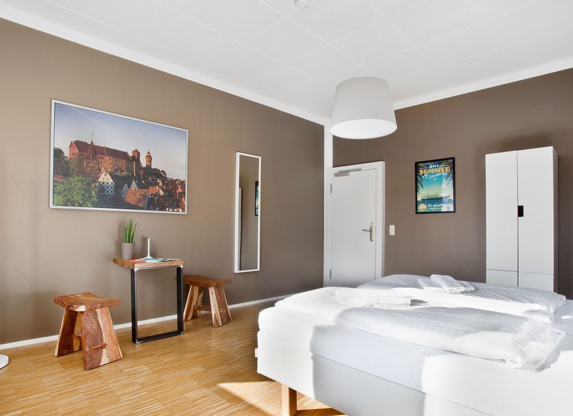 Five Reasons Hostel & Hotel in Nuremberg guest room with twin beds, wood floor, wall art and wardrobe