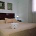 La Teresita Hotel Boutique in Salta: guest room with king bed, bedside lamps and rolled towels