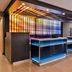 Fairfield Inn and Suites by Marriott Raleigh Cary lobby reception desk with illuminated blue counters and colorful wall art