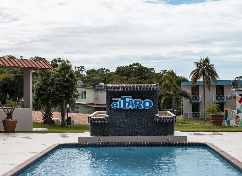 Parador El Faro in Aguadilla with a swimming pool and tropical palm landscaping