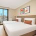Tzl Suites Istanbul guest room with twin beds and city view through floor-to-ceiling window