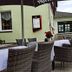 Hotel Restaurant Schwarzes Ross in Oberwiesenthal with an outdoor terrace, wicker chairs, and table settings.