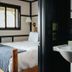 Brentwood Hotel, Saratoga Springs: guest room with bed and adjoining sink vanity.