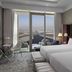 SLS Dubai Hotel & Residences guest room with twin beds and city skyline views in Dubai