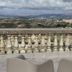 Enna Inn Centro terrace with lounge chairs and panoramic mountain city views in Enna