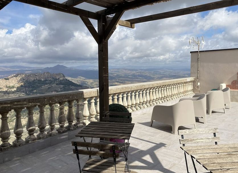 Enna Inn Centro terrace with seating and panoramic hilltop mountain views in Enna