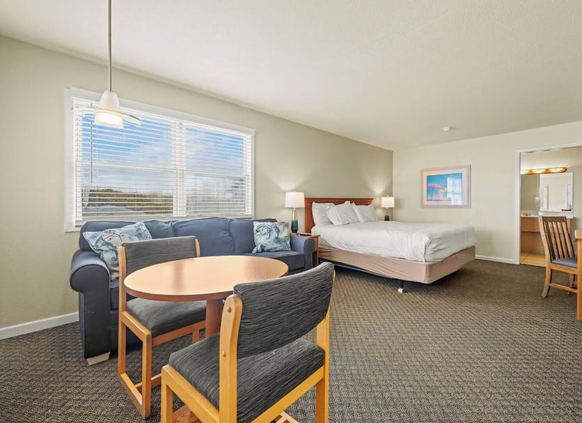 Sea Gull in Hatteras guest room with sofa, bed, dining table and window light
