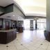 Hilton Garden Inn Valdosta lobby with front desk, tiled floor, and bright glass entrance