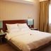 Nan Xiang Hotel - Guiyang guest room with a neatly made bed, bedside lamps, and sheer window curtains