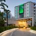 Wyndham Garden Lara in Antalya with illuminated entrance, palm trees and modern hotel exterior