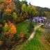 Trillium Resort & Spa in Port Sydney with wooded grounds, autumn trees, and a lodge by the lawn