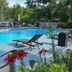 The Villas on Lake George pool deck in Diamond Point with lounge chairs, flowers and wooded surroundings