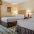 Quality Hotel Conference Center Cincinnati Blue Ash guest room with two double beds and bedside lamps in Cincinnati