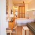 Casa Bassa in Valencia: compact hotel room with twin beds, desk, sofa and oval mirror