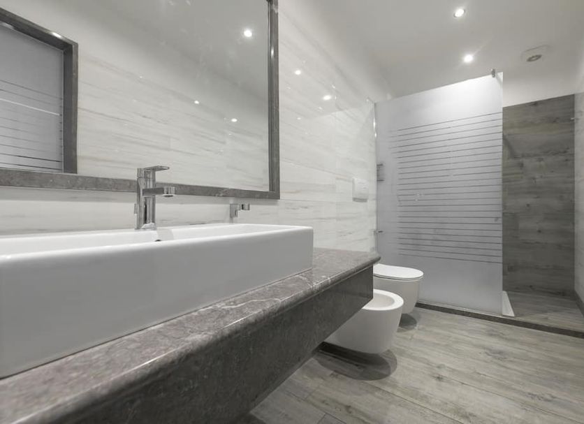 Garda Suite Hotel bathroom in Limone sul Garda with double sink, shower, and bidet