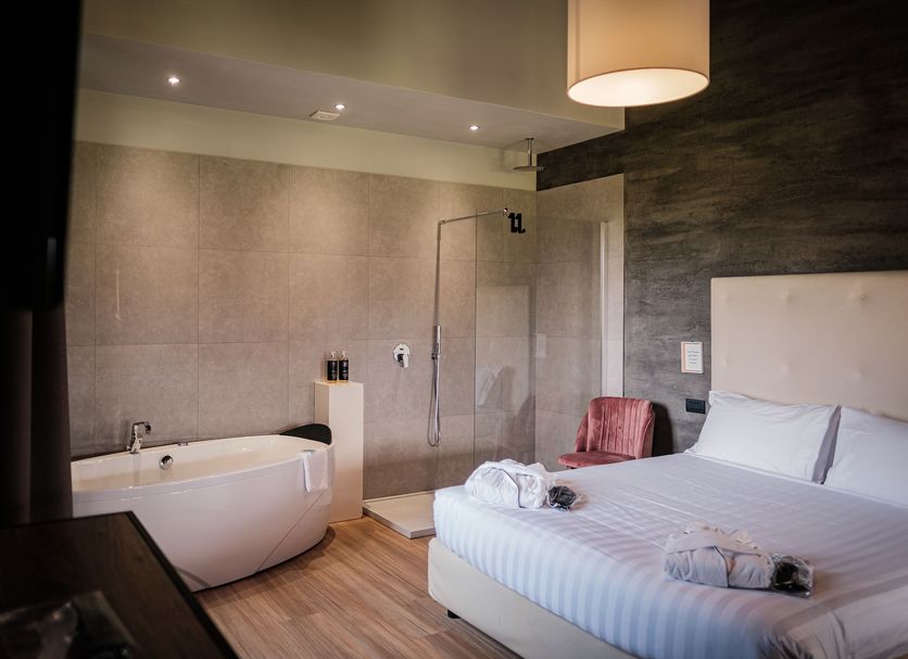 Antico Borgo di Sutri in Sutri guest room with freestanding tub, walk-in shower and bed