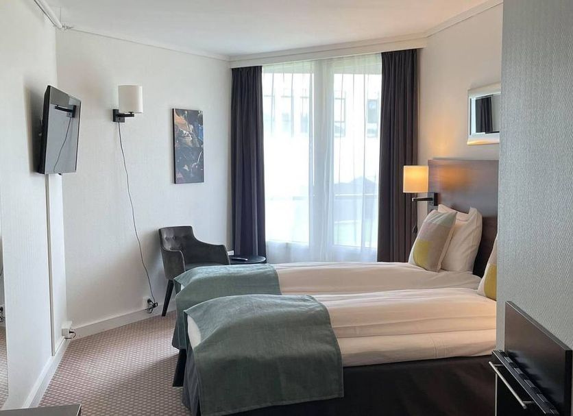 Hardangerfjord Hotel, Øystese: guest room with two twin beds, wall-mounted TV, and window with curtains