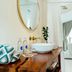 Zazen Boutique Resort & Spa Ko Samui bathroom with wooden vanity, round mirror, and freestanding tub